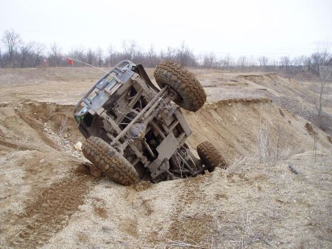 1992 Ford Bronco - An off-road vehicle has become stuck after tipping into a steep dirt embankment.