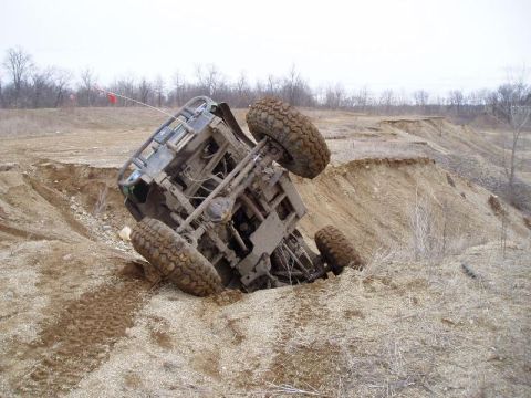 1992 Ford Bronco - This vehicle has rolled over and is stuck in a steep dirt ditch.