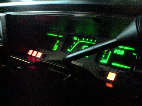 1991 Ford Taurus - The digital dashboard of a 1991 Ford Taurus displays fuel level and other information with green and red illuminated indicators.