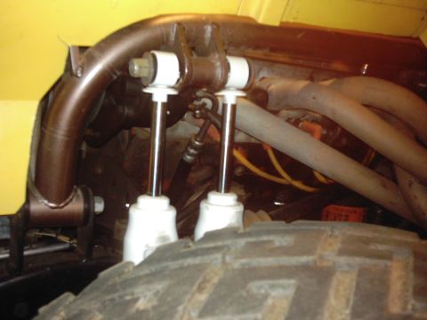 1978 Ford Bronco - Close-up view of the front suspension components and tire of a vehicle.