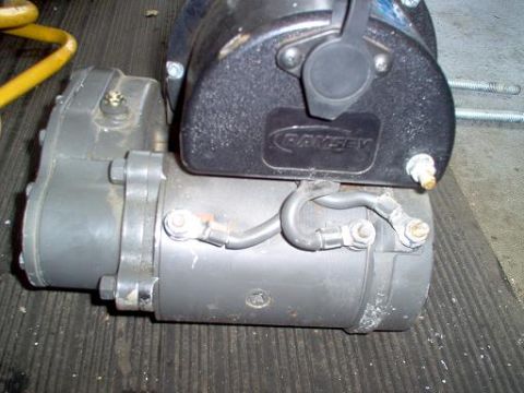 1988 Ford Bronco - A close-up view of a winch motor assembly, showing its various components and wiring.