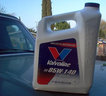 1988 Ford Bronco - A bottle of Valvoline SAE 85W-140 gear oil is placed on the hood of a vehicle.