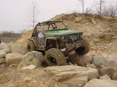 1992 Ford Bronco - This modified Suzuki is navigating a challenging rocky terrain.