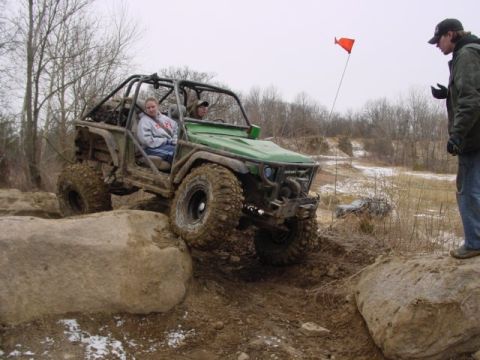1992 Ford Bronco - Off-road buggy navigates a rocky trail with a spotter watching.