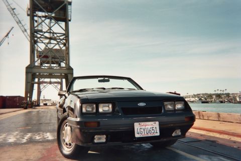 1985 Ford Mustang - Front view of a 1985 Ford Mustang convertible with a California license plate.