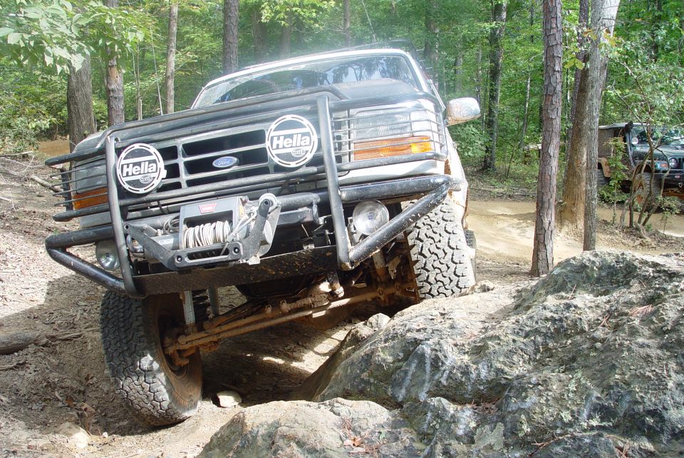 Small thumbnail of a white off-road SUV with brush guard on a dirt trail