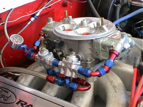 1979 Ford Bronco - Custom fuel system components, including a carburetor and pressure regulator, are installed on an engine.