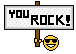 1968 Ford Mustang - A sign with the words 'YOU ROCK!' and a smiley face wearing sunglasses is held up against a black background.