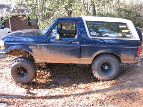 1995 Ford Bronco - This lifted 1995 Ford Bronco is ready for off-road adventures, as evidenced by its large tires and mud-covered body.