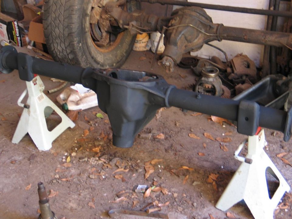 Rear axle assembly on jack stands, showing differential housing and axle tubes