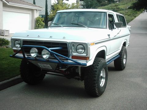 1978 Ford Bronco - This 1978 Ford Bronco features a custom blue bumper with auxiliary lights and a lifted suspension.