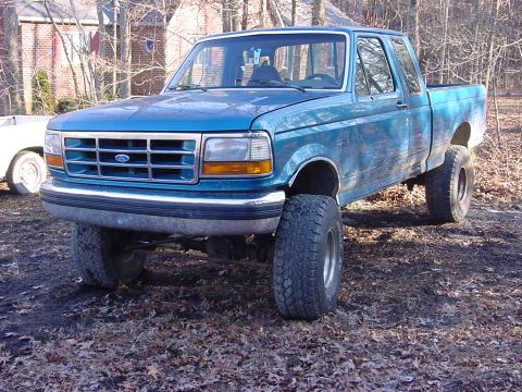 1993 Ford F-150 - This blue 1993 Ford F-150 pickup truck is shown from the front 3/4 angle.