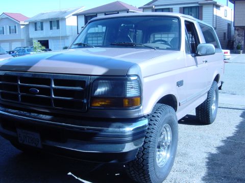1996 Ford Bronco - This 1996 Ford Bronco is shown from the front three-quarter view, highlighting its chrome grille and bumper.