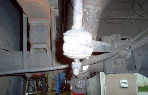1988 Ford Bronco - Undercarriage view focusing on the leaf spring and suspension system, likely a part replacement or repair.