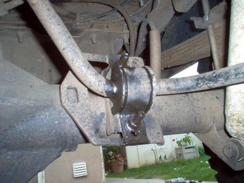 1988 Ford Bronco - Undercarriage view shows the sway bar and its mounting bracket attached to the rear axle housing.