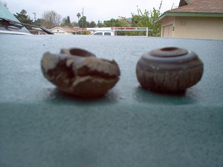 1988 Ford Bronco - Two worn rubber bushings are shown, one of which is significantly damaged.