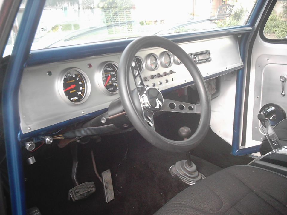 Custom aluminum dash with tach and speedometer in stripped truck interior