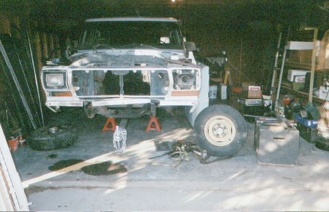 1978 Ford Bronco - This 1978 Ford Bronco is in a garage, elevated on jack stands with its front end disassembled for repairs.