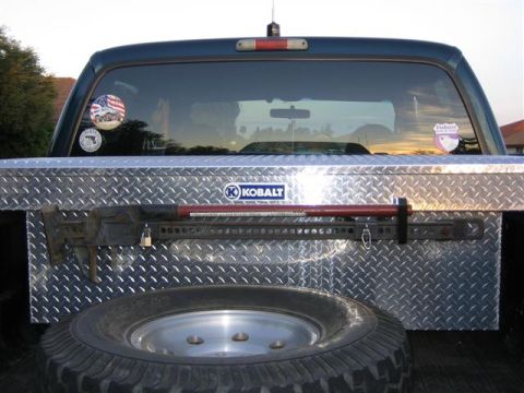 1999 Ford F-250 - Toolbox and jack secured in the truck bed, ready for action.