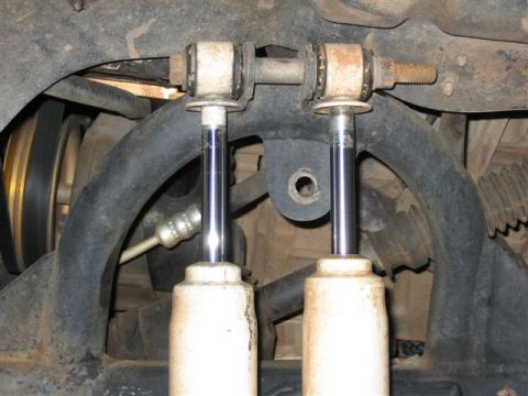 1994 Ford Bronco - Close-up view of front suspension parts, including shocks and linkage.