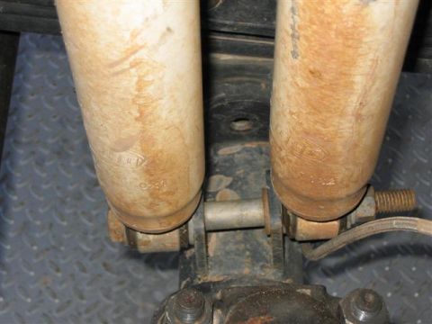 1994 Ford Bronco - The rear shock absorbers show some wear and tear, with visible part numbers stamped on them.