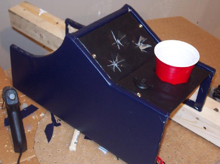 Blue custom center console with a red solo cup and a black power outlet
