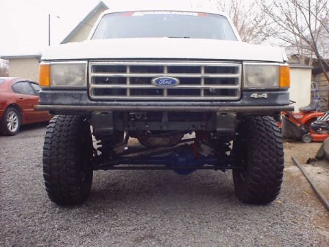 1988 Ford Bronco - This lifted Ford truck features a prominent grille and 4x4 badging, suggesting a model year around 1987.
