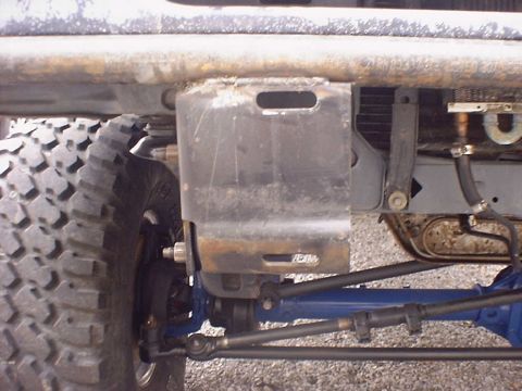 1988 Ford Bronco - Close-up view of off-road vehicle's front bumper and suspension system, a Supermotors watermark.