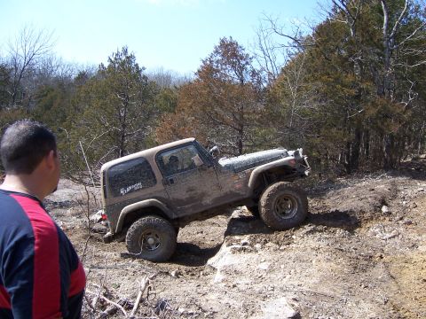 1999 Jeep TJ - A 1999 Jeep TJ navigates a challenging off-road course, demonstrating its 4x4 capabilities.