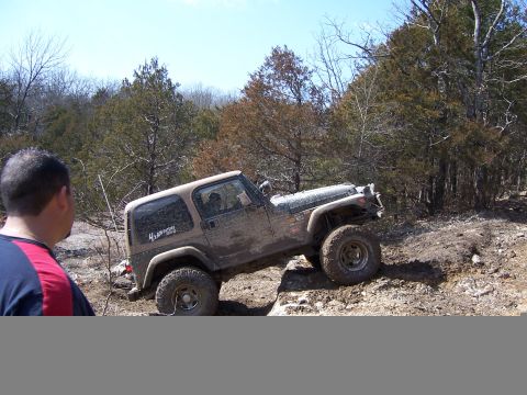 1999 Jeep TJ - Jeep TJ navigating a challenging off-road course on a sunny day.