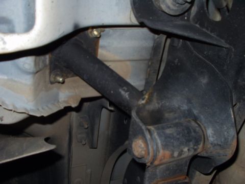 1993 Ford Bronco - Close-up view of a roll cage bracket mounted to the vehicle's frame.
