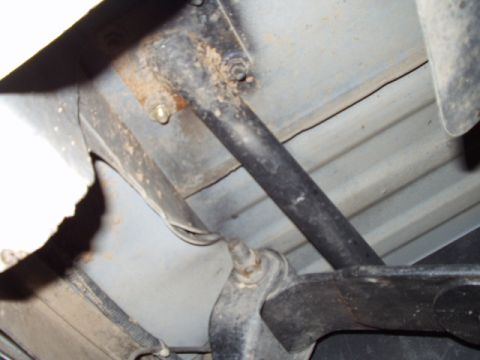 1993 Ford Bronco - Underside view of vehicle frame and suspension components, showing rust and wear.