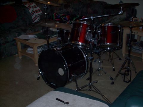 1986 Ford Bronco - A red and black drum set is set up indoors, likely for practice or performance.