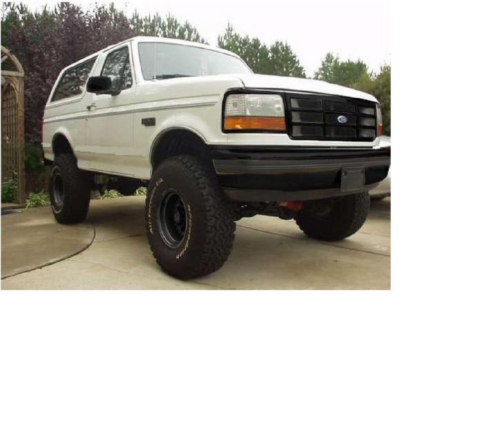 White 1992 Ford Bronco with black grille and off-road tires