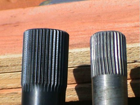 1979 Ford Bronco - Comparison of two axle shafts, one black and one silver, with visible splines and a watermark at the bottom.
