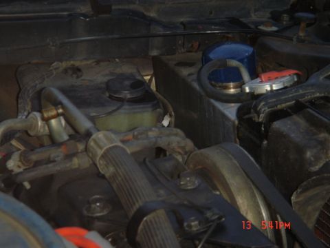 1975 Ford Ranchero - Tank on shelf in front left corner of engine compartment.
