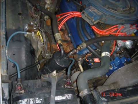 1975 Ford Ranchero - Promaster coil mounted on the front right end of the engine. Unilite coil with vacuum advance.