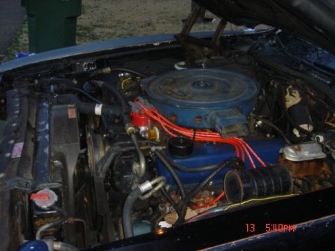 1975 Ford Ranchero - The engine bay of a vehicle is shown with various components including the engine block, air cleaner, and distributor.