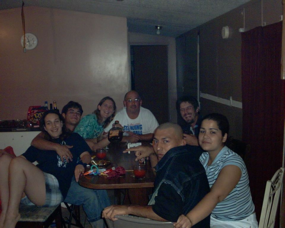 Group of people gathered around a table with drinks