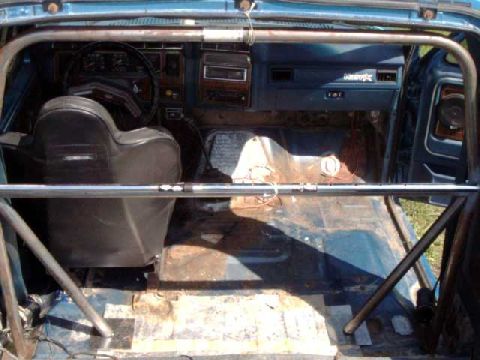 1984 Ford Bronco - mounting frame support to main hoop. PLan to use a large 1/4" thick plate to strengthen floor (sound matt is the template).