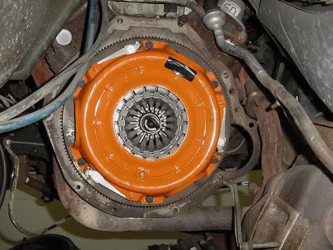 1995 Ford Bronco - Close-up view of a vehicle's clutch and flywheel assembly, showing the orange housing and internal components.