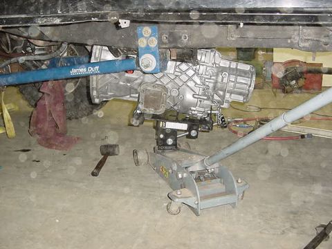 1995 Ford Bronco - Close-up view of a vehicle's undercarriage, focusing on the transmission and suspension components.