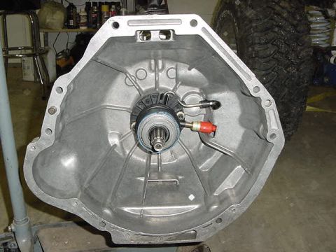 1995 Ford Bronco - Close-up of a transmission bell housing, showing the clutch release bearing mechanism.