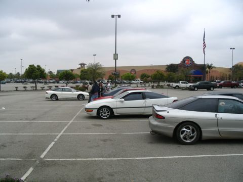 1995 Ford Probe - A silver 1995 Ford Probe is parked in a lot, showing its rear profile and spoiler.