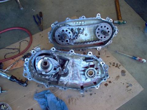 1988 Ford Bronco - Transfer case components laid out on cardboard with various tools nearby.