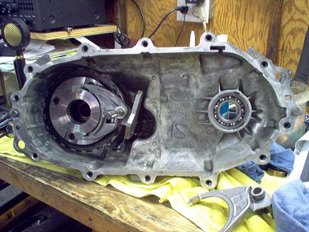 1988 Ford Bronco - Disassembled transfer case assembly showing internal components and a bearing.