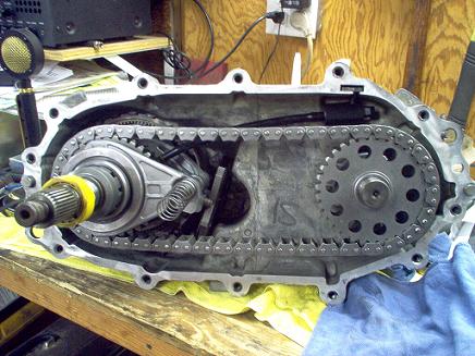 1988 Ford Bronco - Close-up view of the internal components of a transfer case, showing the chain and sprockets.