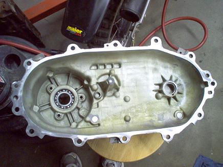 1988 Ford Bronco - Close-up of an open transfer case housing, showing internal components and a Maier logo on a nearby fender.