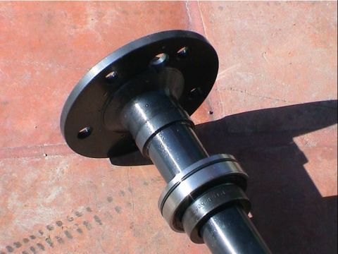1979 Ford Bronco - Close-up of a vehicle axle shaft with bearings and a mounting flange.