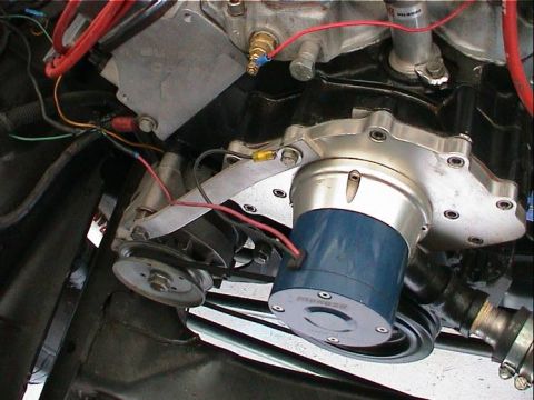 1979 Ford Bronco - Engine bay detail showing an aftermarket electric water pump installation with visible wiring and pulleys.